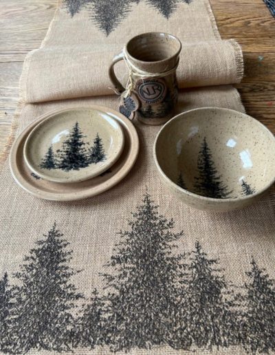 Glazed pine tree pottery with pen and ink burlap table runner